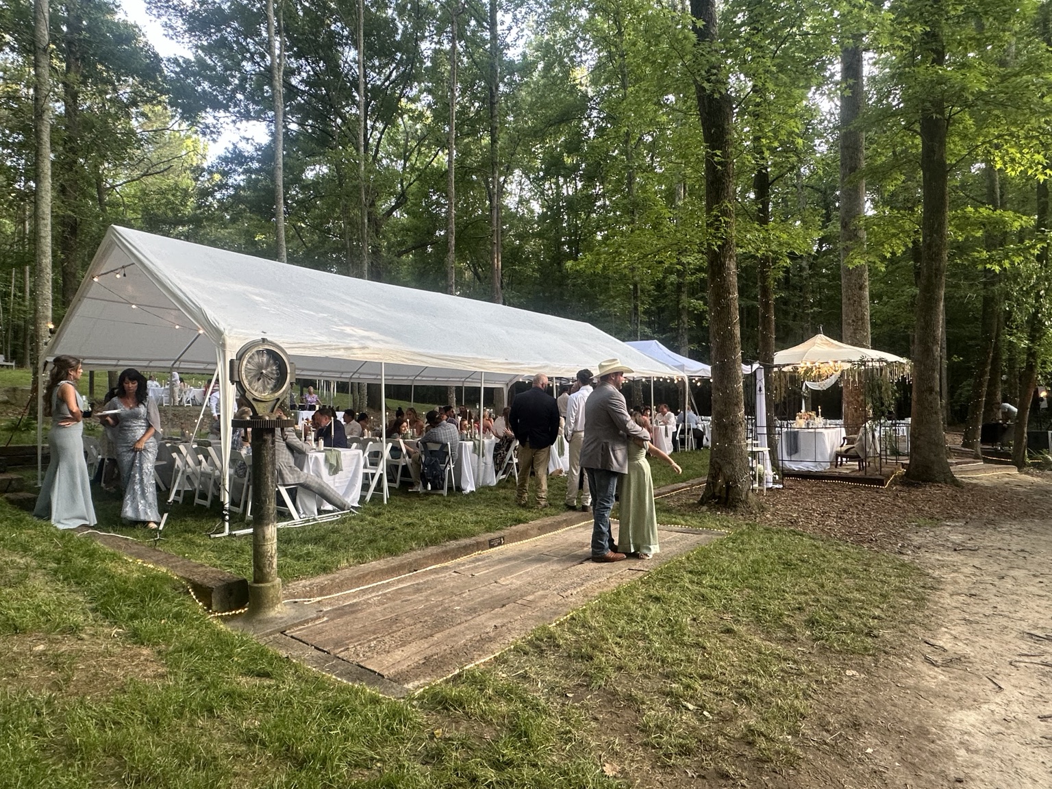 Tented wedding reception in the wooded entertaining area